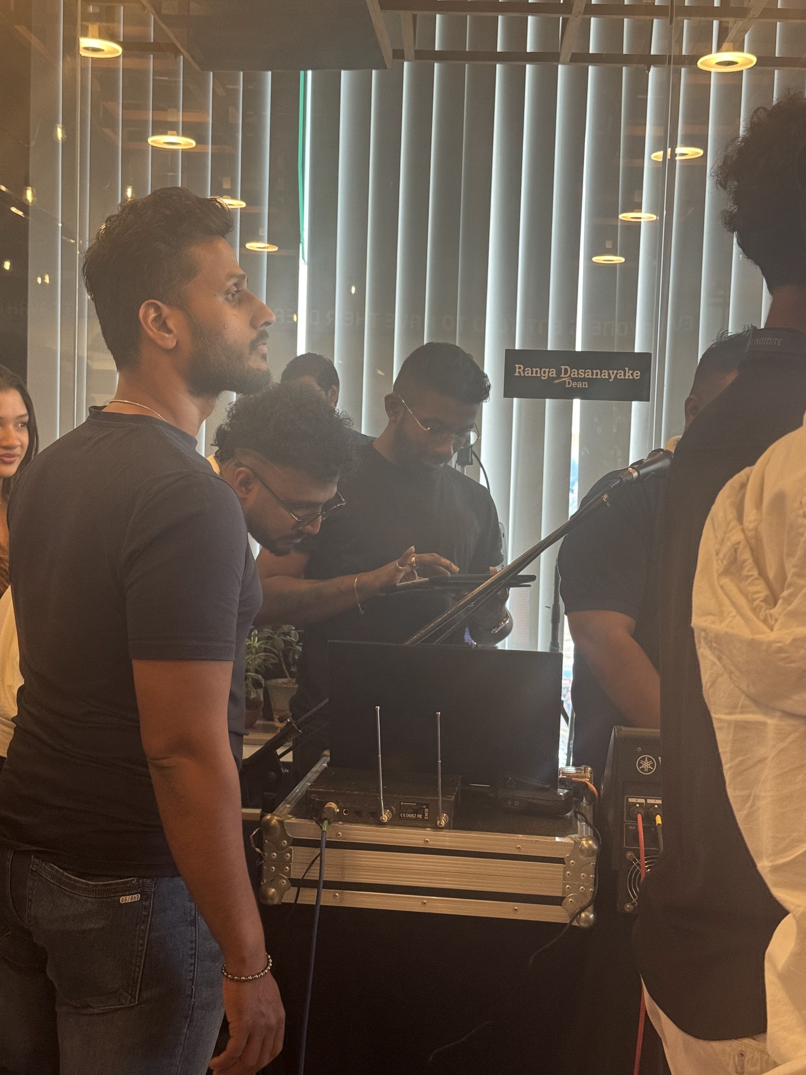 Crew reviewing footage on a production monitor backstage