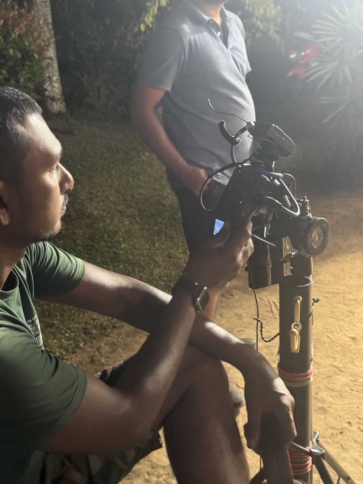Crew adjusting camera equipment on set